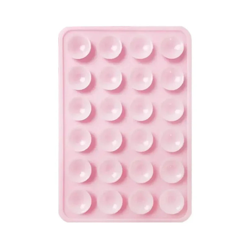 Support de téléphone en silicone rose avec plusieurs supports circulaires pour montage mural.