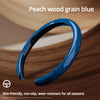 A close-up of a blue peach wood grain steering wheel cover shown on a wooden surface.