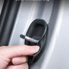 A hand is operating a soft fit silicone door damping guard on a car door.