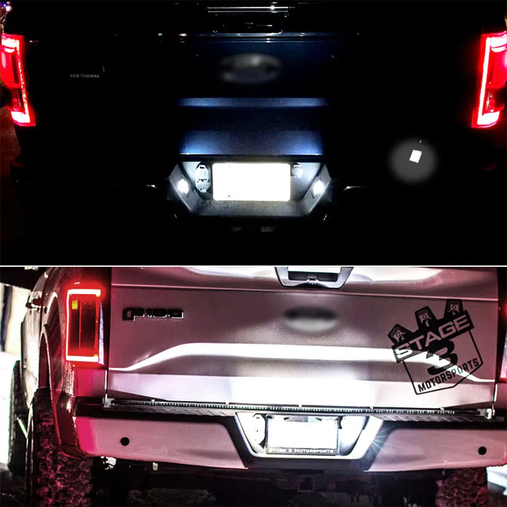 Close-up view of LED license plate lights installed on a silver Ford F-150 or Raptor truck.