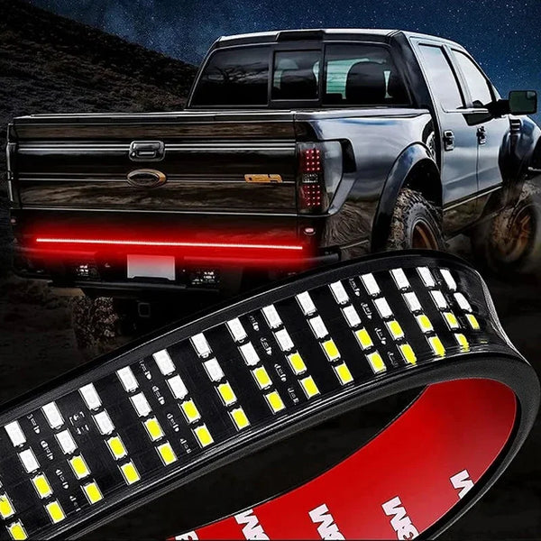 A high-intensity LED light bar mounted on the tailgate of a silver pickup truck.