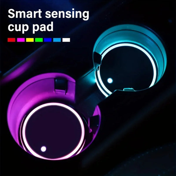 A close-up view of a smart sensing cup pad with glowing LED lights in a car cup holder.