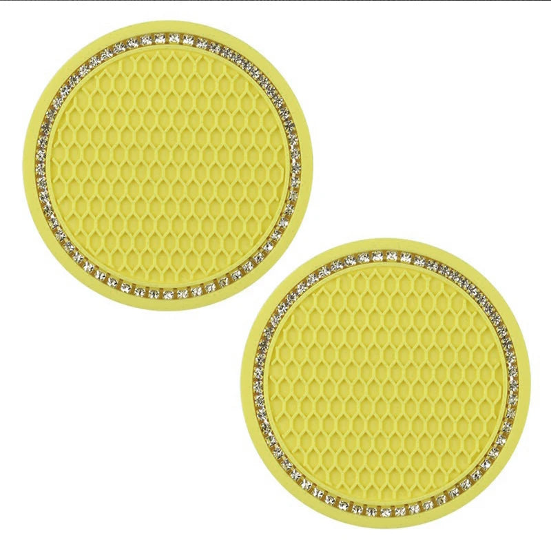 A set of yellow decorative rhinestone coasters with a honeycomb texture.