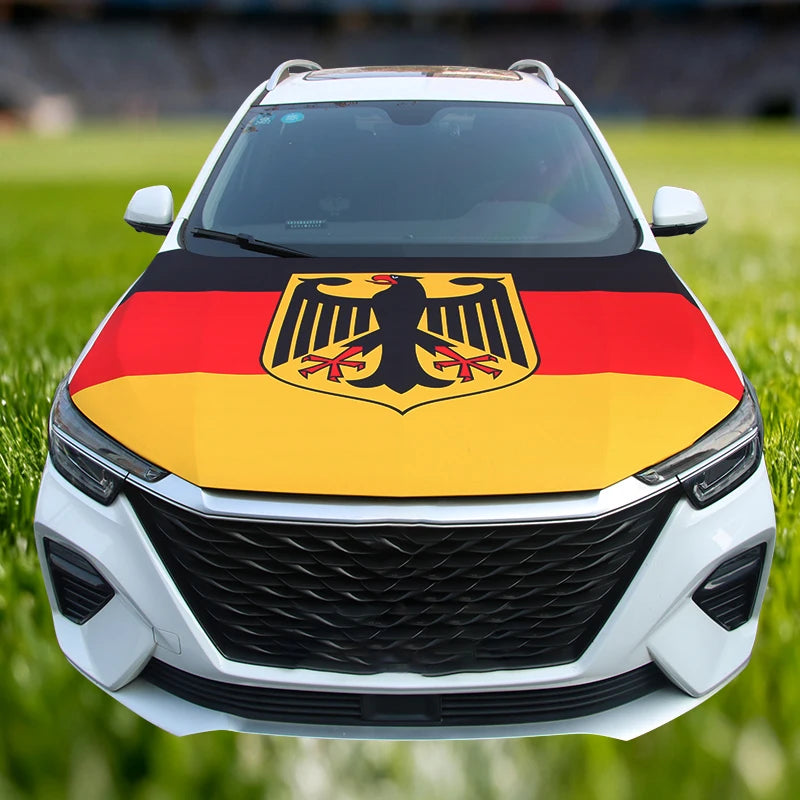 A white car hood decorated with a German flag emblem featuring a black eagle on a yellow and red background.