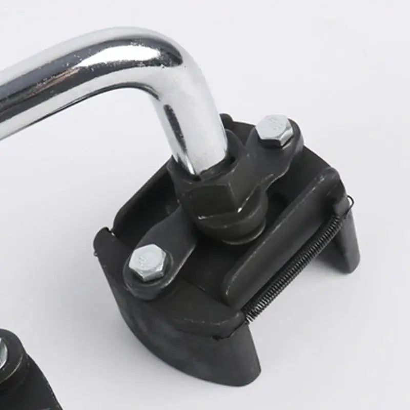 A close-up view of a black adjustable oil filter wrench with a chrome handle and serrated jaws.
