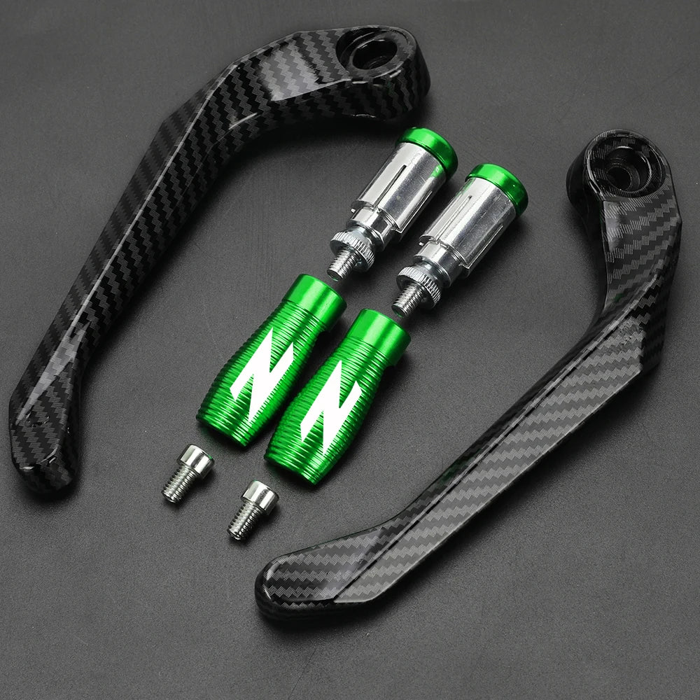 A set of black carbon fiber motorcycle levers and handguard protectors with green accents.