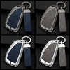 A pair of durable zinc alloy car key cases in black and blue leather accents shown from the side.