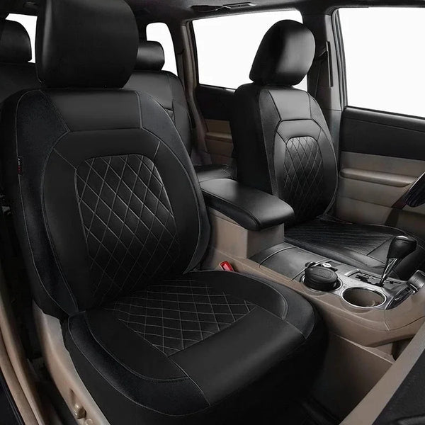 Interior view of a vehicle showing a black leather seat and door panel with quilted stitching.