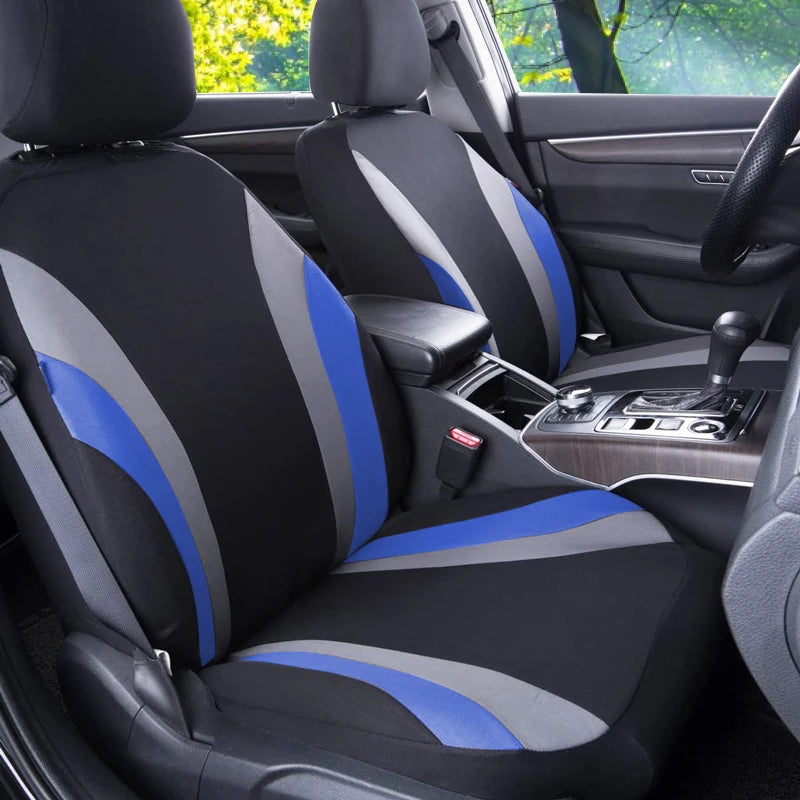 A black car seat with blue and gray fabric covers installed in a vehicle interior.