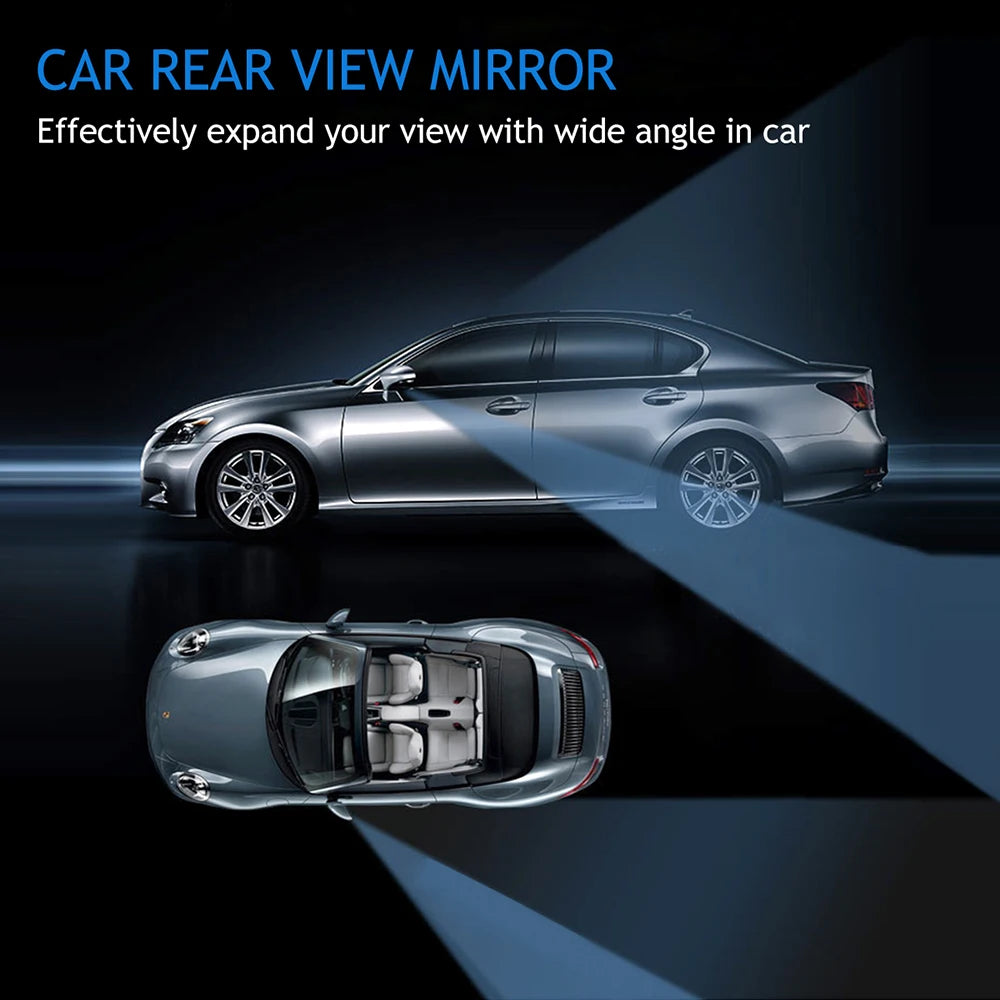 A car rear view mirror is shown with a wide angle lens mounted on a silver sedan.
