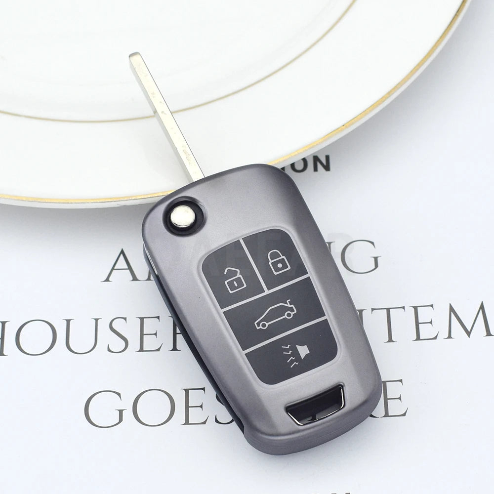 A close-up of a gray universal car key cover resting on a white circular background.