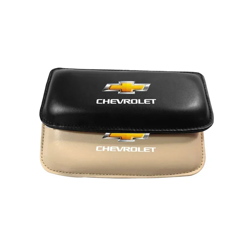 A pair of premium leather knee pads for car driving, featuring black and tan colors with Chevrolet emblems.