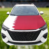 A white car hood decorated with a red and white flag design.