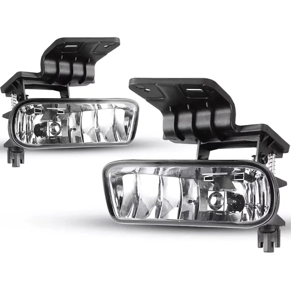 A pair of clear lens fog light assemblies with black mounting brackets for Chevy Silverado, Suburban, and Tahoe.