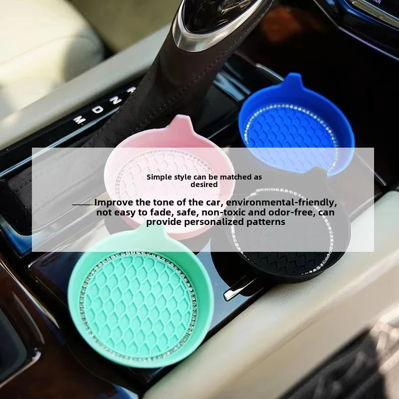 A collection of colorful rhinestone car cup holder coasters in various shades including pink blue and green