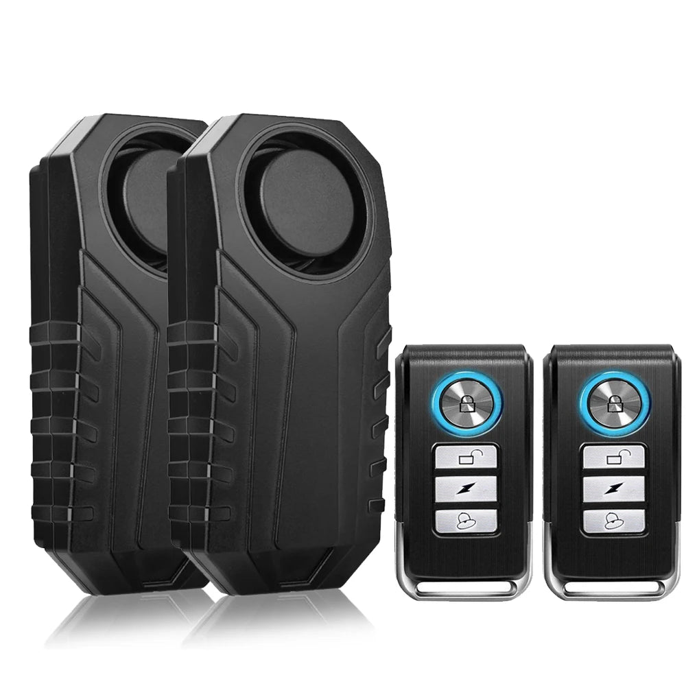 Black wireless bicycle and motorcycle alarm system components, including two main units and two remote controls.