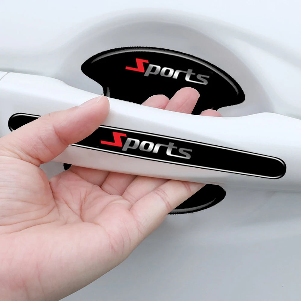 A hand holds a white car door handle with black grips featuring the red Sports logo.