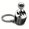 A silver keychain with a spherical top and numbered markings for desk stress relief.