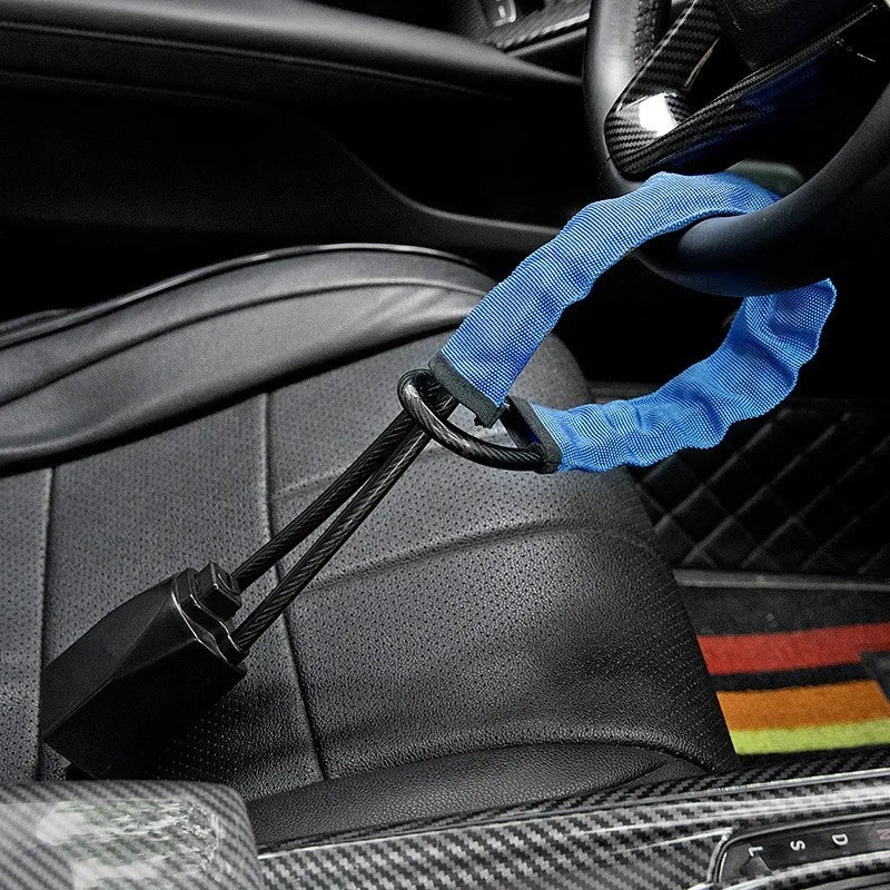 A blue strap is used to secure a universal car steering wheel anti-theft lock to a car seat.