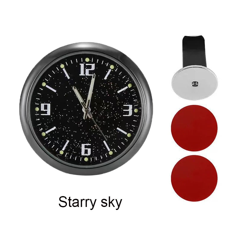 A round, black analog clock face with a starry sky design and a silver mounting plate.