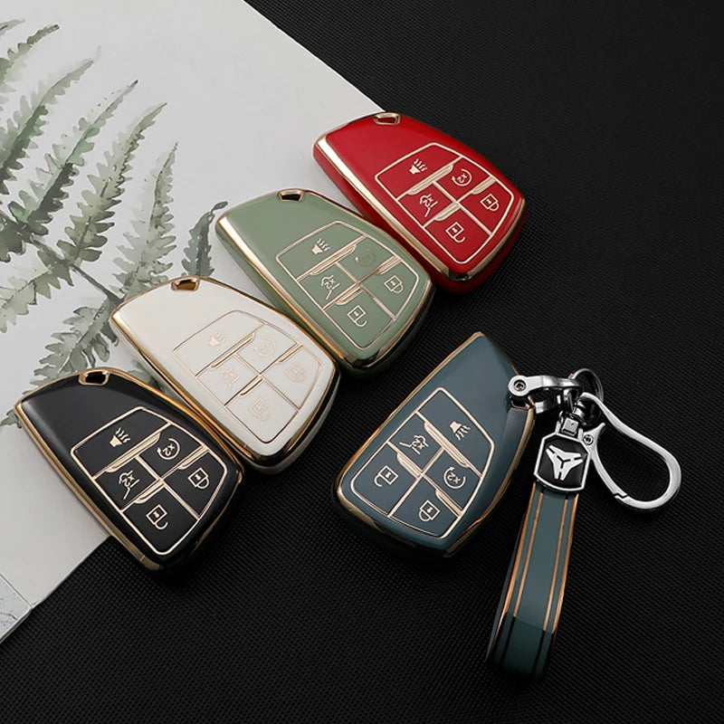 A collection of multi-function car key covers in red, green, and gold tones displayed on a dark surface.
