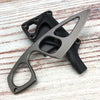 A gray fixed blade knife is shown with a black sheath, resting on a light wooden surface.