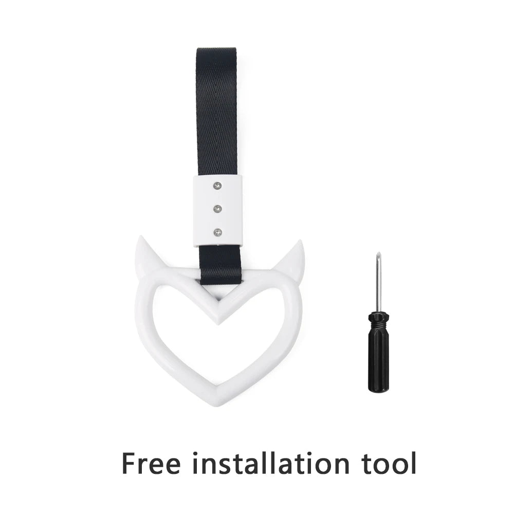 Black strap and white hand pull ring for car rear bumper warning installation.