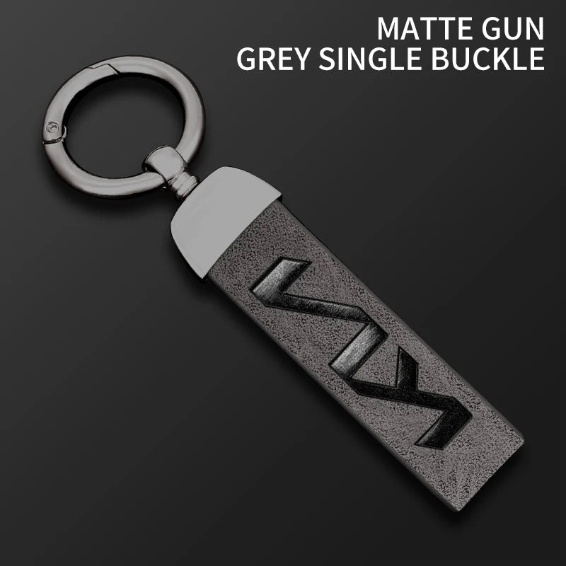A matte grey single buckle gun key featuring a silver loop and a textured leather case.
