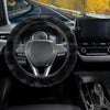Interior view of a car showing a black winter plush steering wheel cover and dashboard.