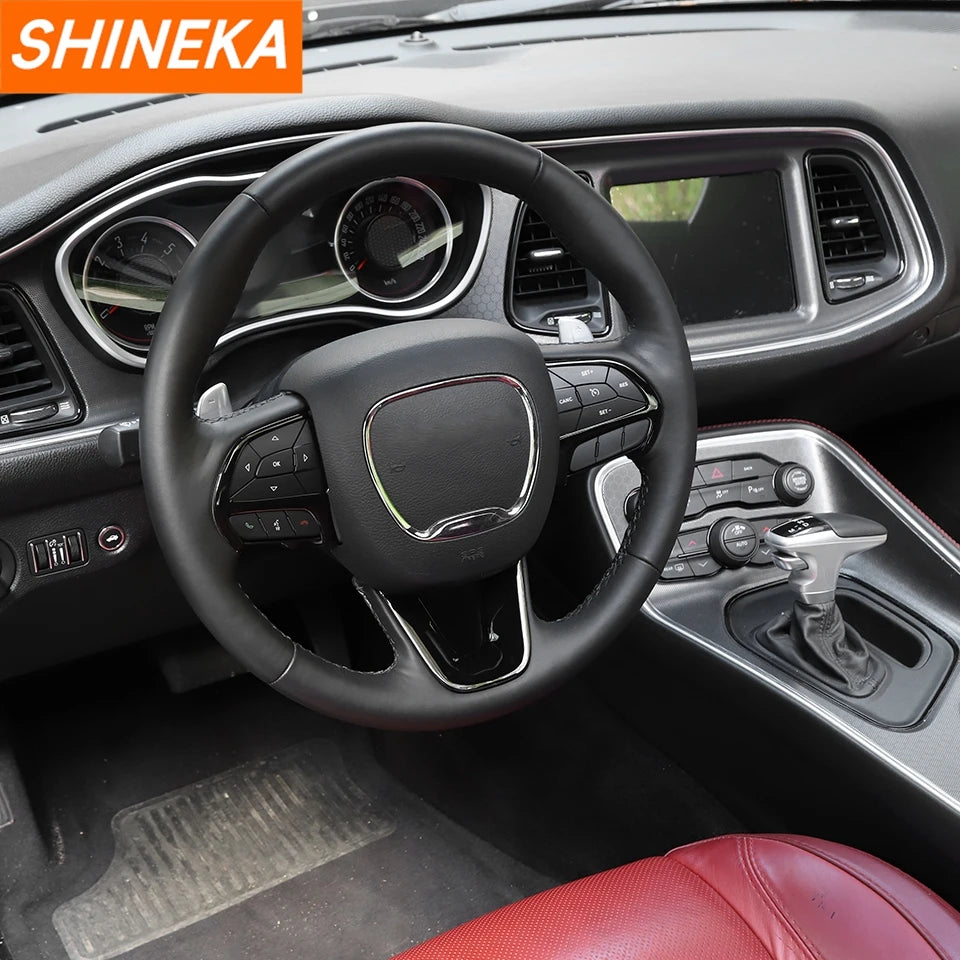 A black steering wheel decoration cover is shown inside a car, featuring a leather-wrapped grip and controls.