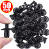 A pile of black plastic rivets and push pins for car bumper fasteners is shown being held by a hand.