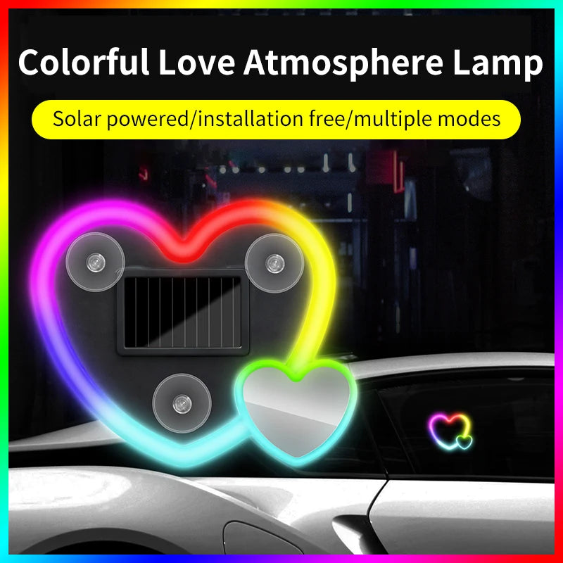 A heart-shaped solar powered lamp illuminates a car interior with colorful light effects.