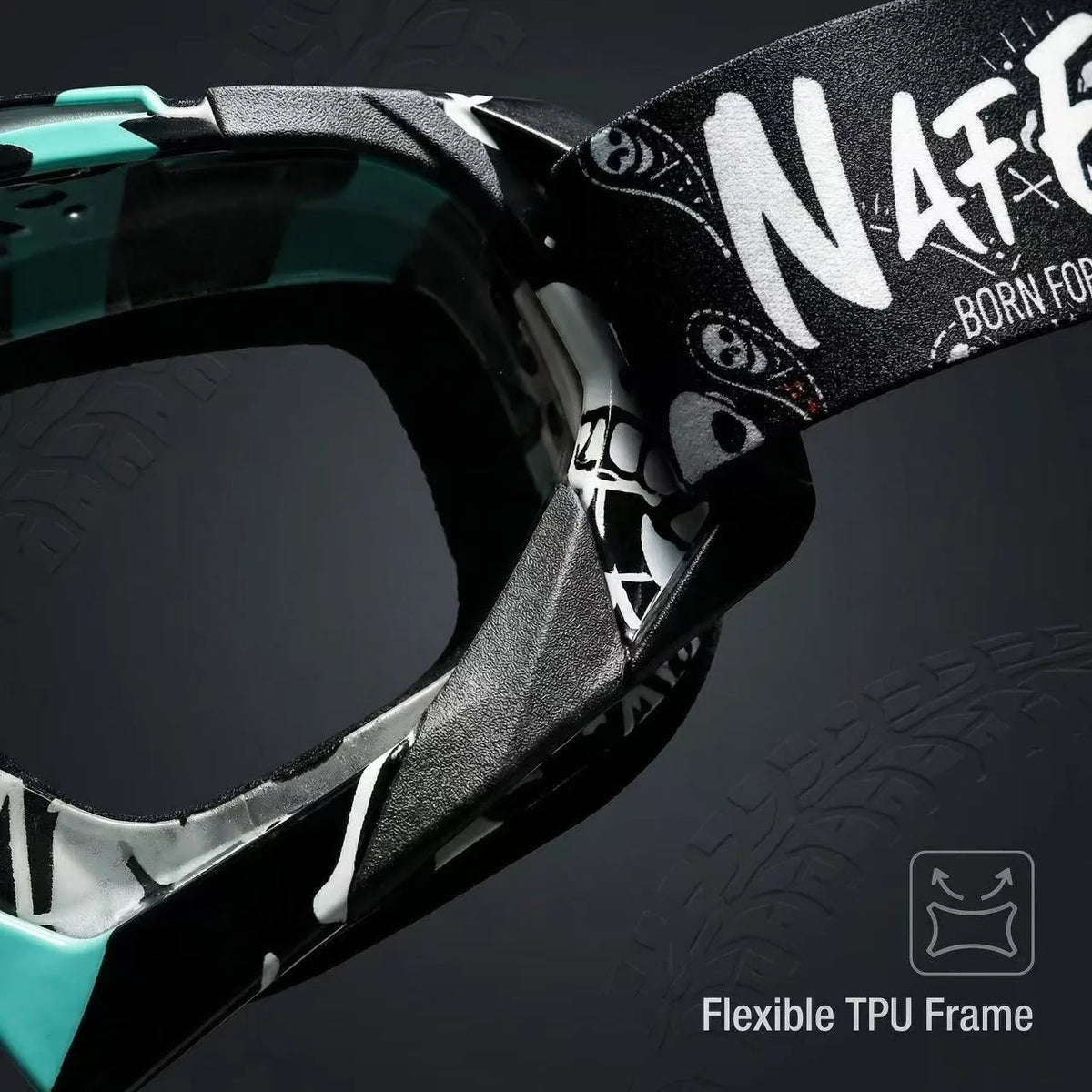 Close-up of a black and teal motorcycle goggle frame with a black strap featuring white text.