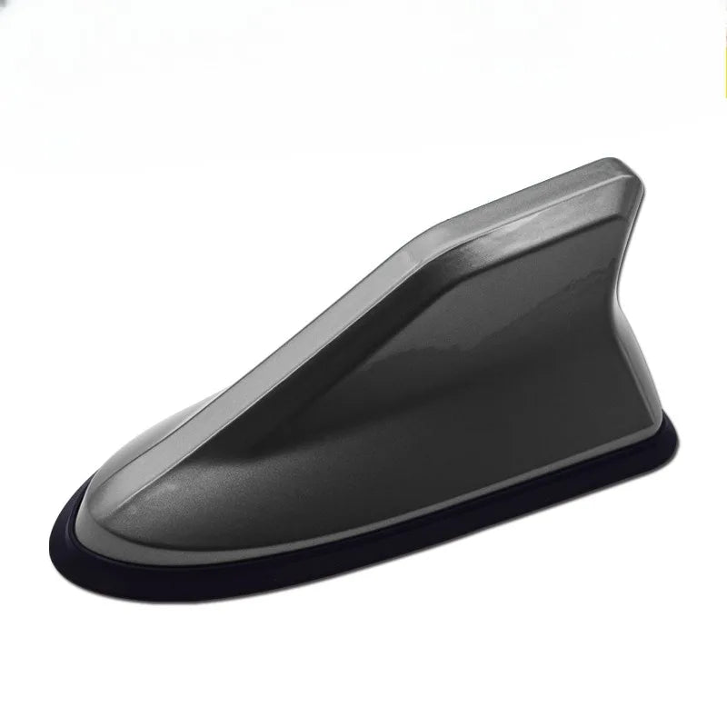 A gray shark fin universal car antenna amplifier with a black base.