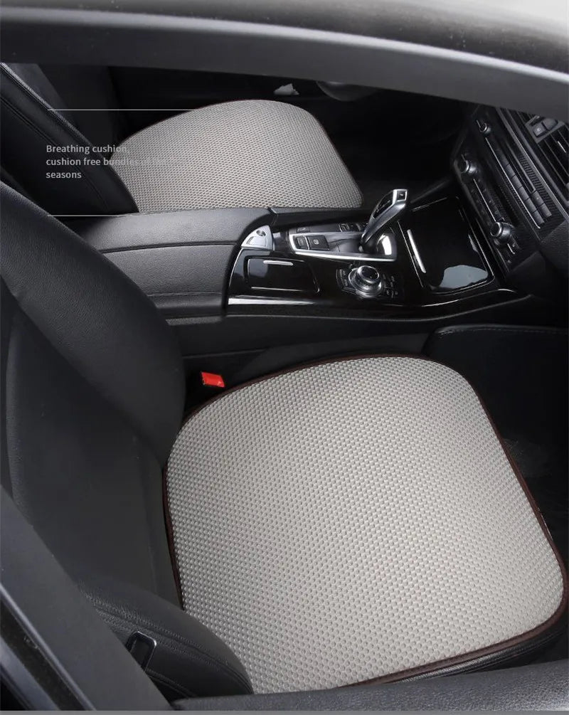 Interior view of a car seat showing a beige breathable cushion and dark upholstery.