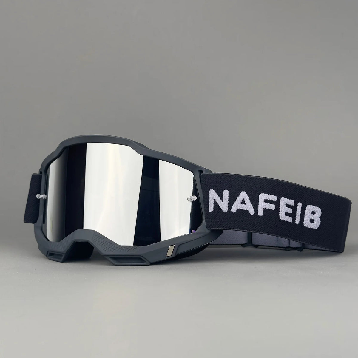 A pair of black off-road racing goggles with a strap featuring the text NAFEIB.
