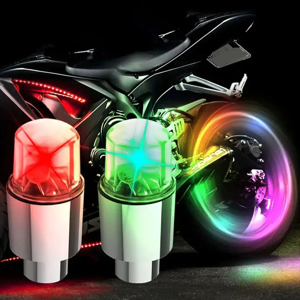 A close-up of universal LED wheel lights mounted on a motorcycle, showing bright red and green illumination.