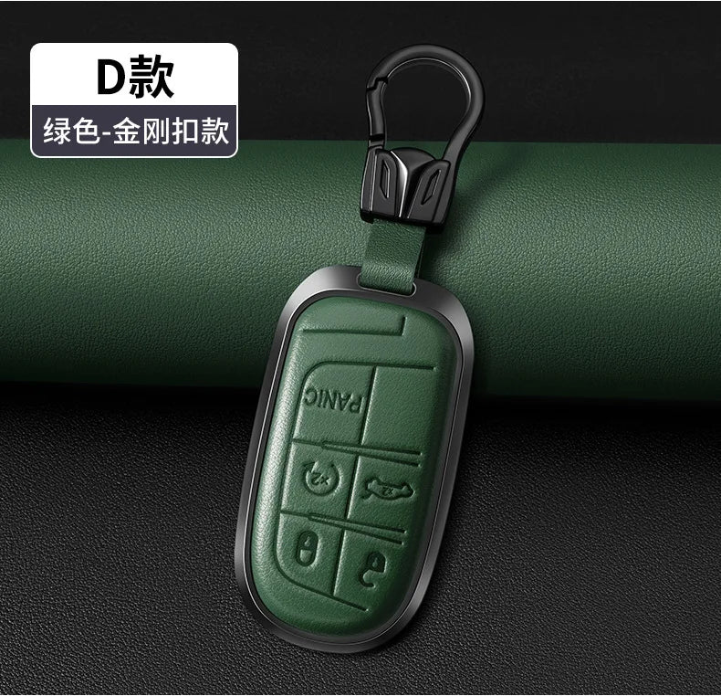 A dark green leather key fob cover with a silver metal clip, shown against a black background.