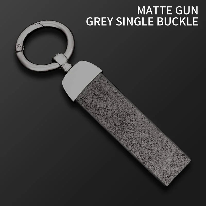 A matte grey single buckle gun key cover with a metal loop and sleeve.