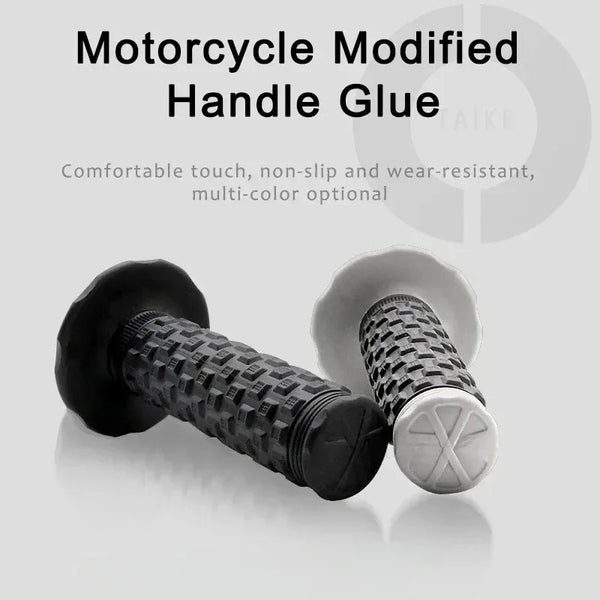 A close-up view of a black motorcycle handlebar grip and a white grip, showing the texture and design.
