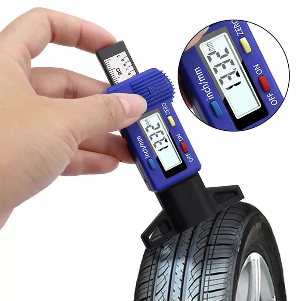 A hand holds a digital tyre depth gauge measuring the tread depth of a tire.