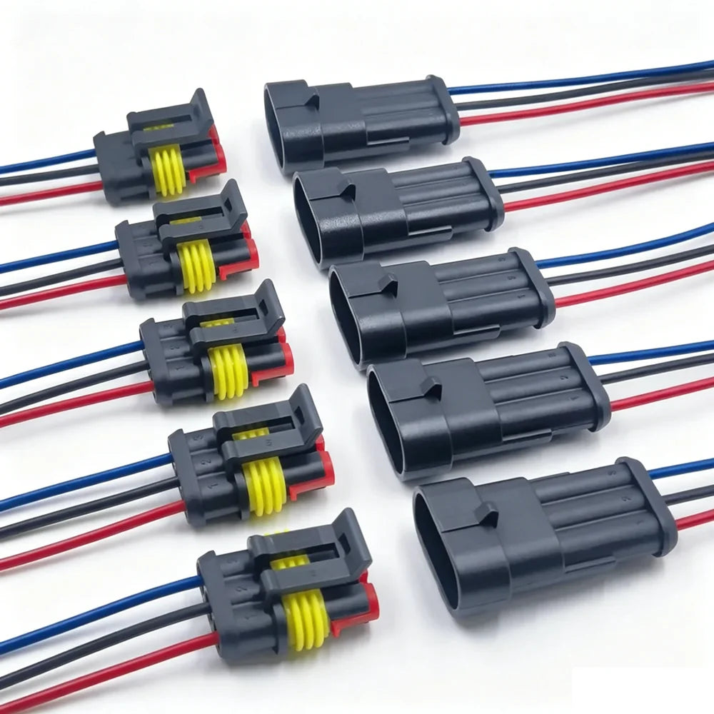 A collection of waterproof electrical connectors with pre-wired red, black, and blue leads.