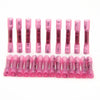 A row of pink heat shrink wire connectors with various sizes and insulation types displayed horizontally.