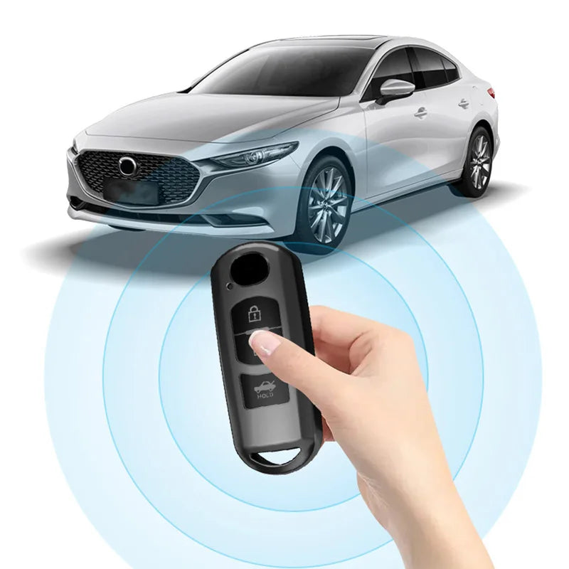 A hand holds a universal car key cover over a Mazda vehicle, demonstrating its use for unlocking.