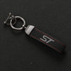 A black suede leather car keychain with a silver split ring and red stitching.