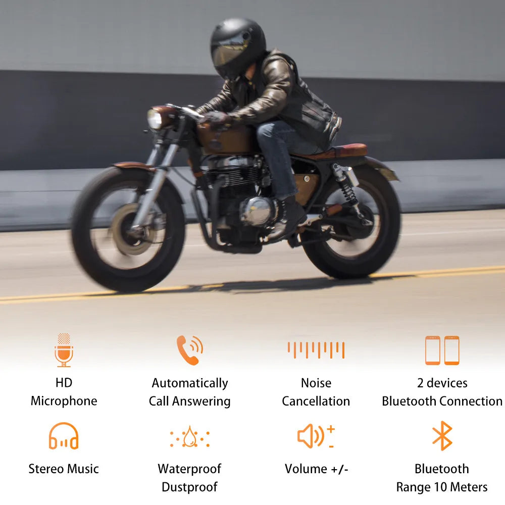 A person wearing a black motorcycle helmet and headset is riding a motorcycle on a road.