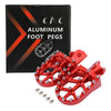 A box of aluminum foot pegs for motorcycles with several bright red CNC-machined pegs displayed outside the box.