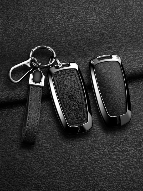 A black aluminum alloy key fob cover for a Ford vehicle, shown with its attached chain and leather strap.