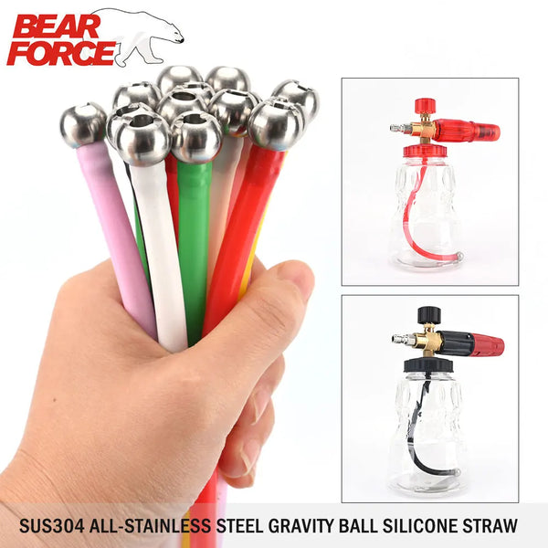 A hand holds a bundle of stainless steel gravity ball silicone straws for cleaning or drinking.