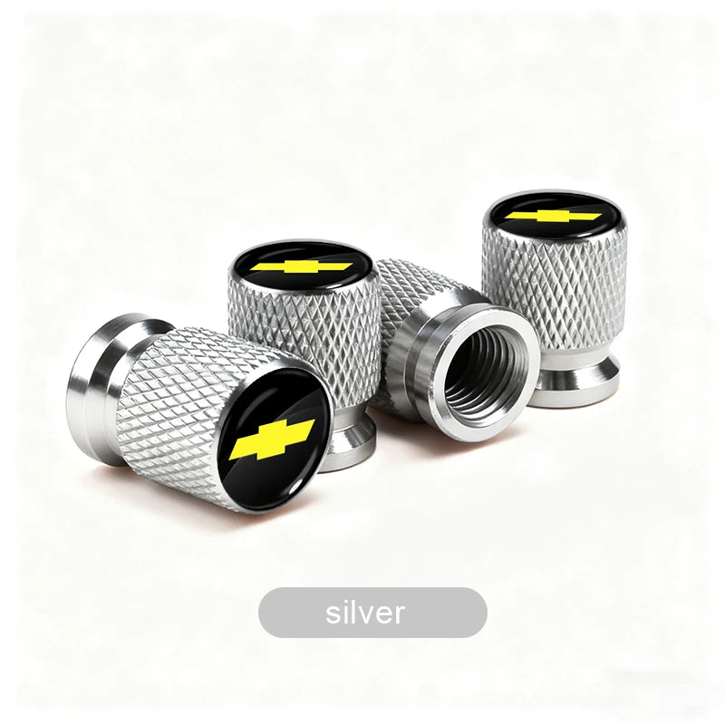 Silver aluminum tire valve covers with yellow lightning bolt accents shown in various angles